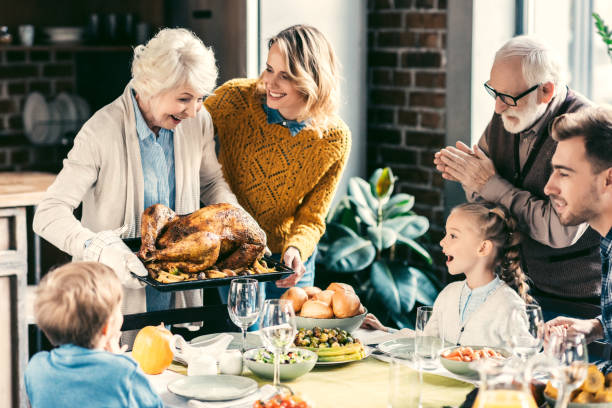 A family preparing a Thanksgiving meal together with elderly parents