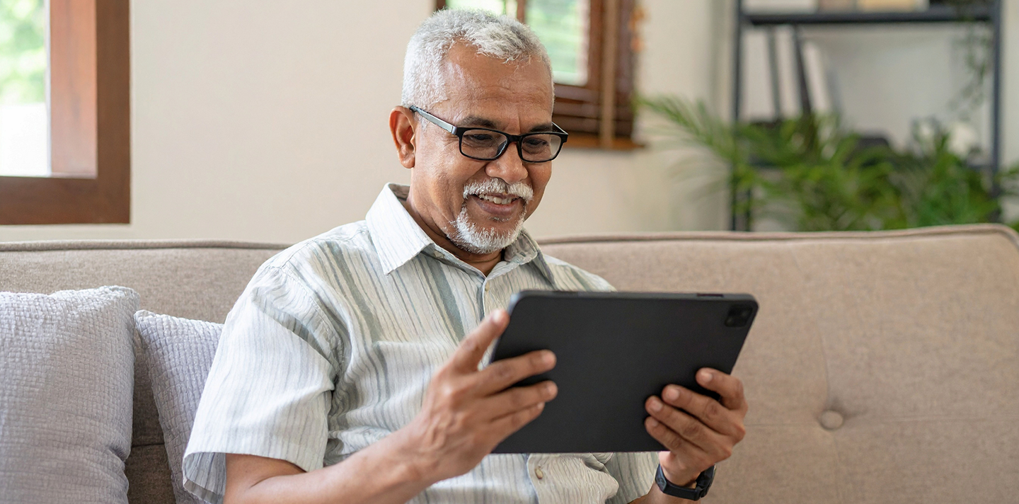 A senior man smiling while relaxing at home in Alabama
